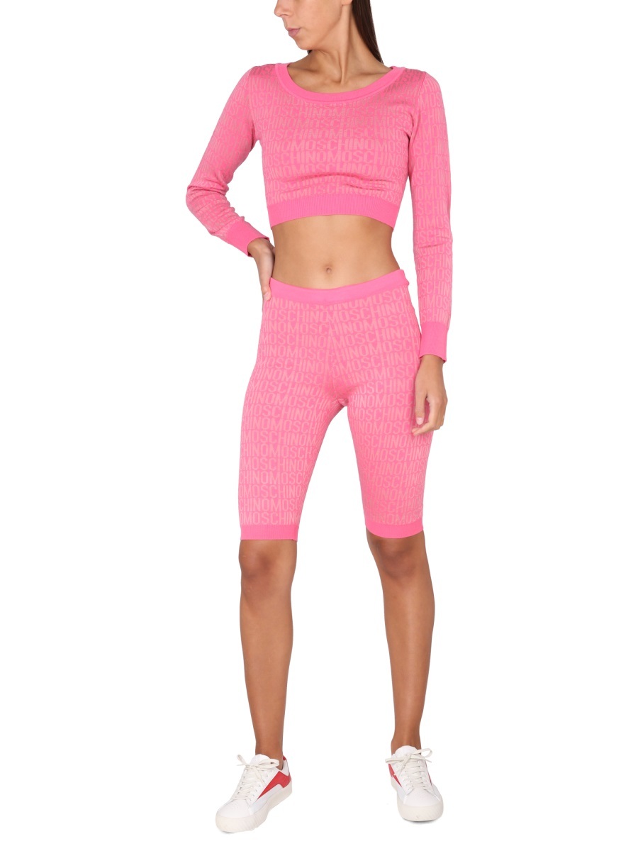 Moschino Cropped Pullover With Allover Logo Pattern In Pink