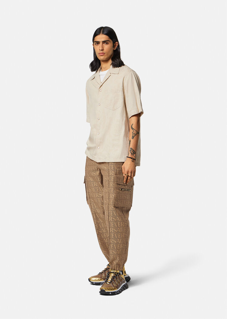 Versace Allover Logo-print Cargo Trousers In Brown