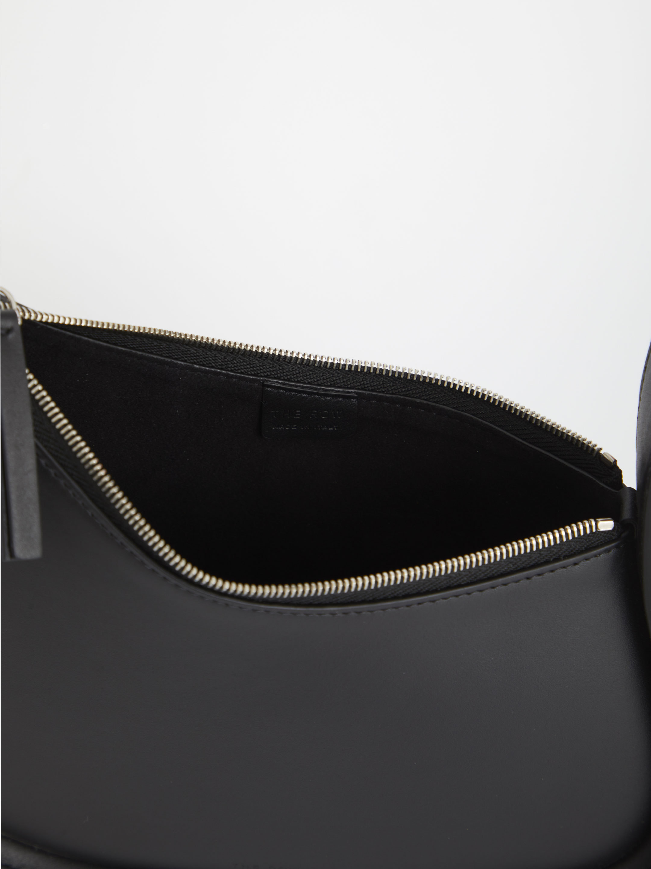 The Row Zippered Half-moon Handbag In Black