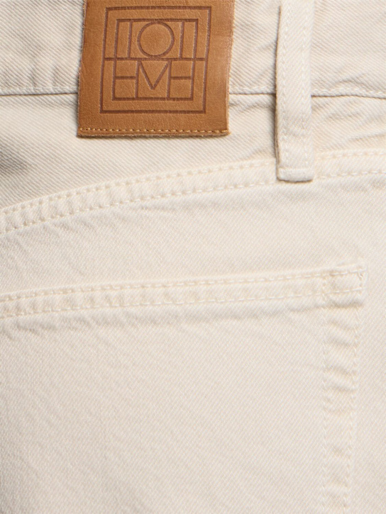 Shop Totême Twisted Seam Mid Rise Denim Jeans