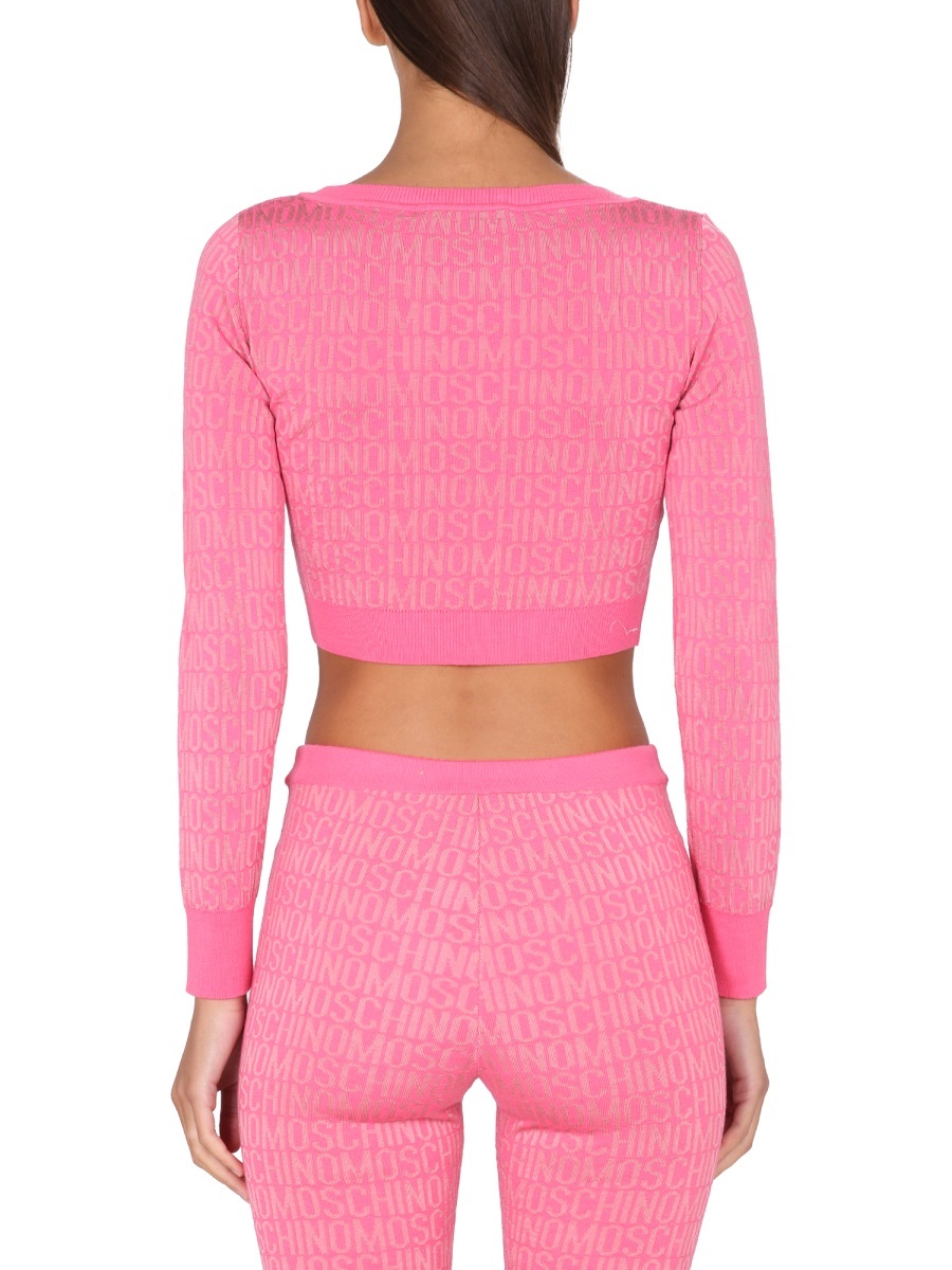 Moschino Cropped Pullover With Allover Logo Pattern In Pink