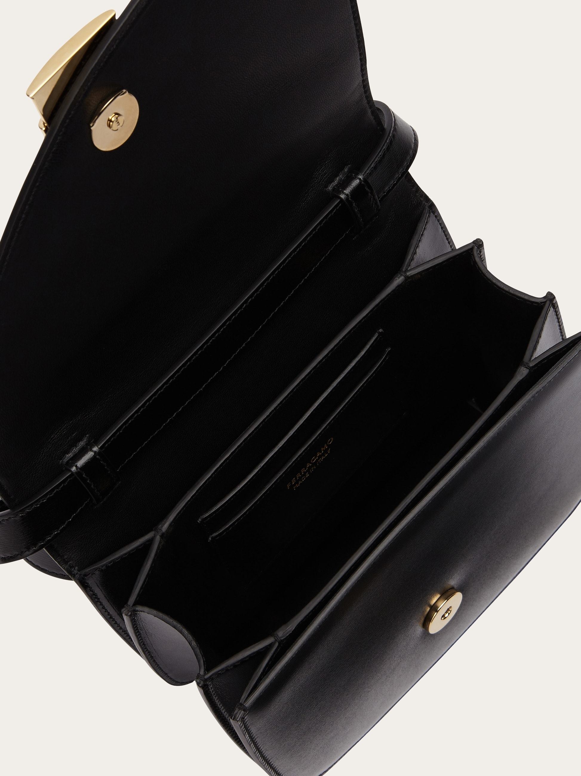 Shop Ferragamo Flip Shoulder Bag In Black