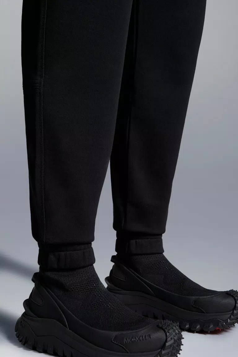 Shop Moncler Embossed Logo Trackpants In Black
