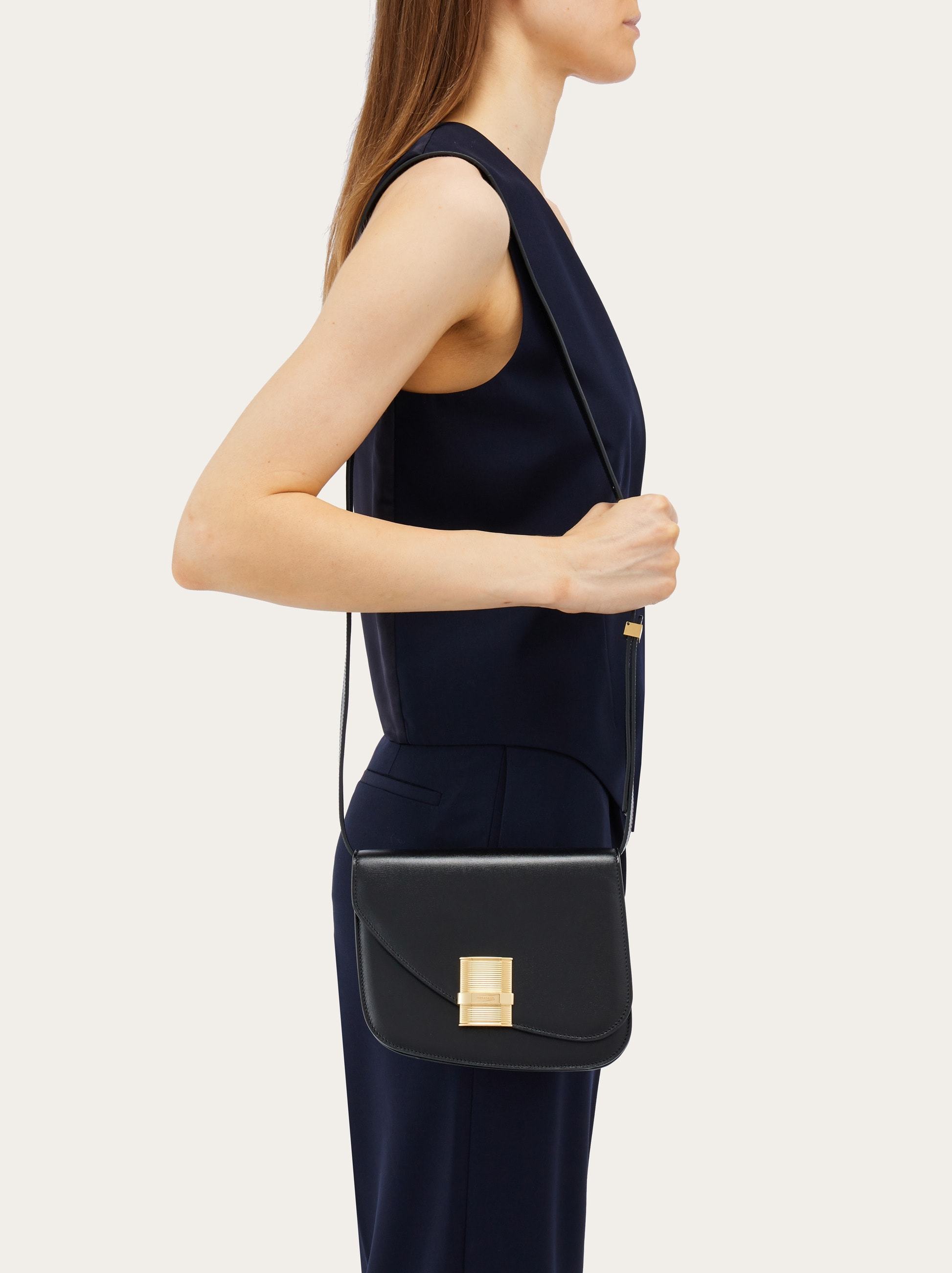 Shop Ferragamo Flip Shoulder Bag In Black