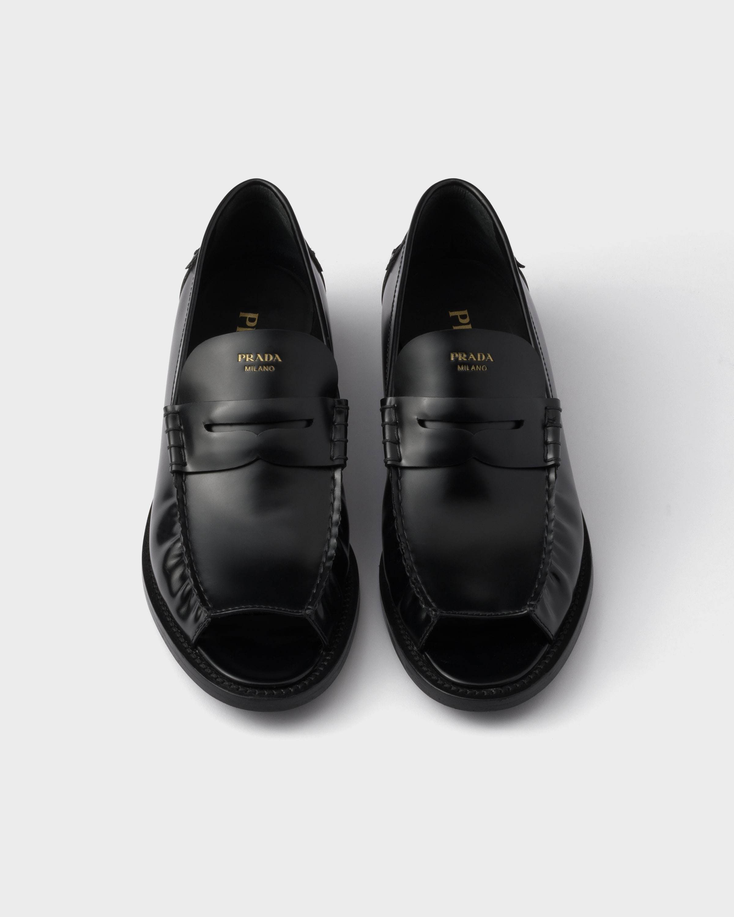 Prada Logo-printed Penny Loafers In Black