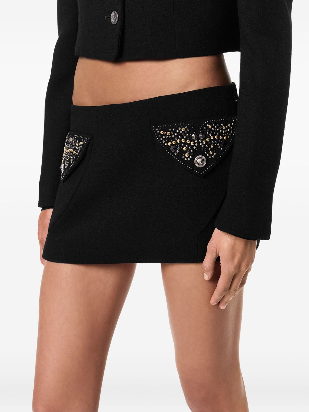 Versace Chic Fitted Mini Skirt With Embellished Pockets In Black