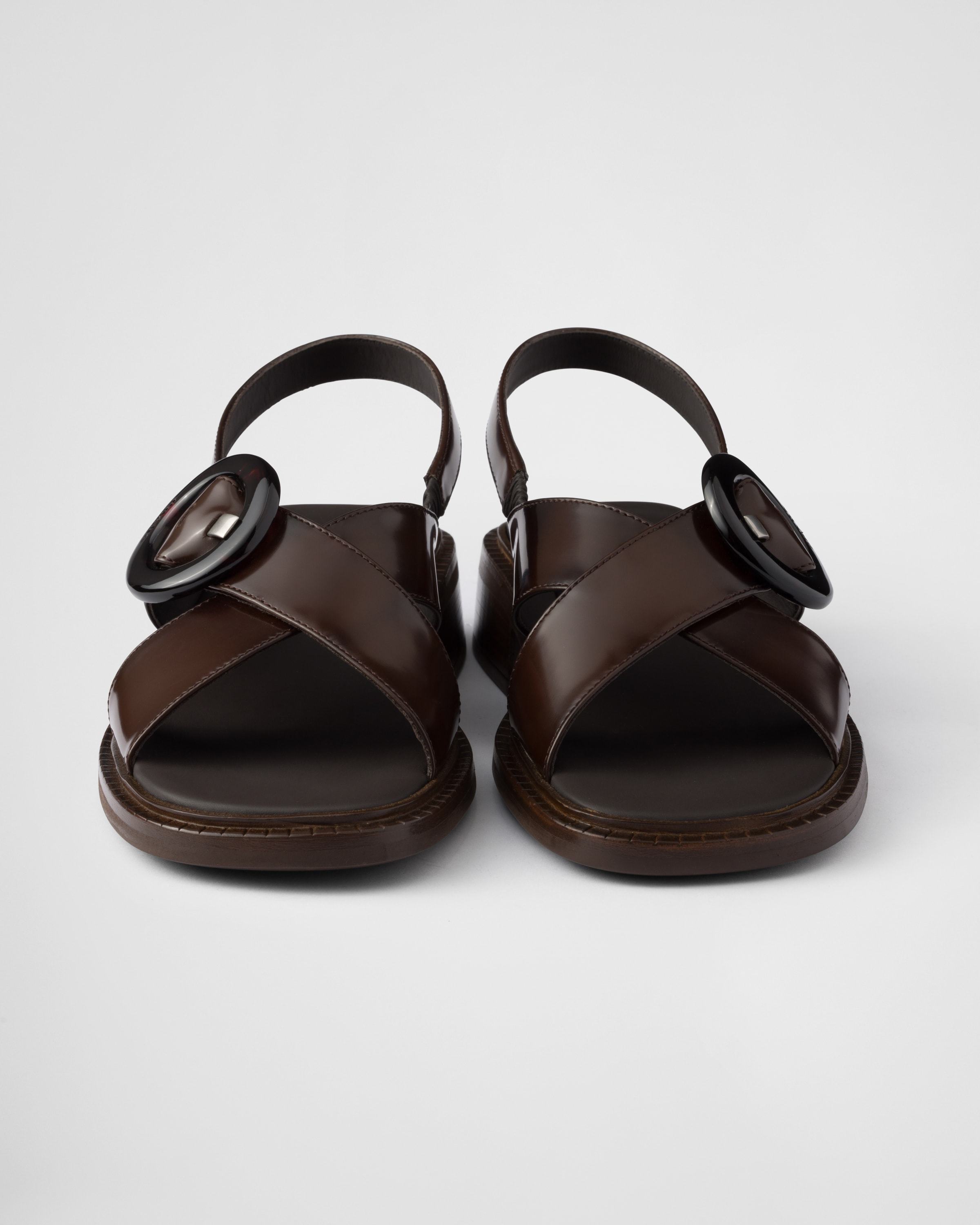 Prada Brushed Leather Crisscross Band Sandals With Plexiglas Buckle In Ochre