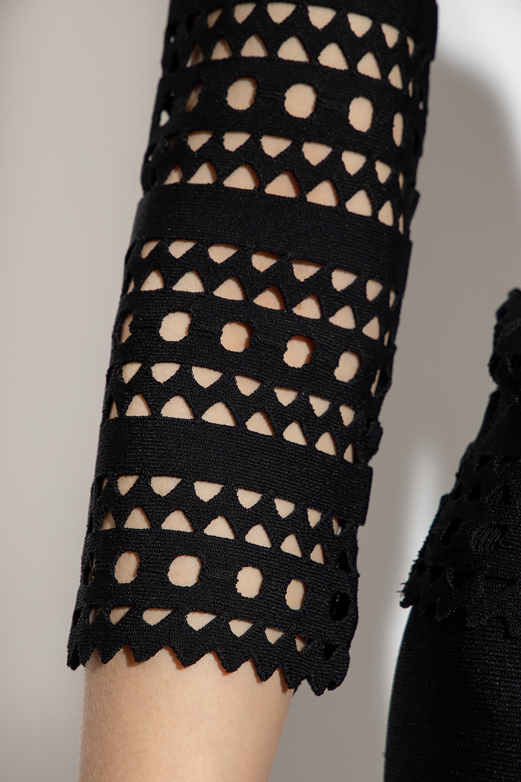 Alaïa Open-knit Off-shoulder Longsleeved Top In Black