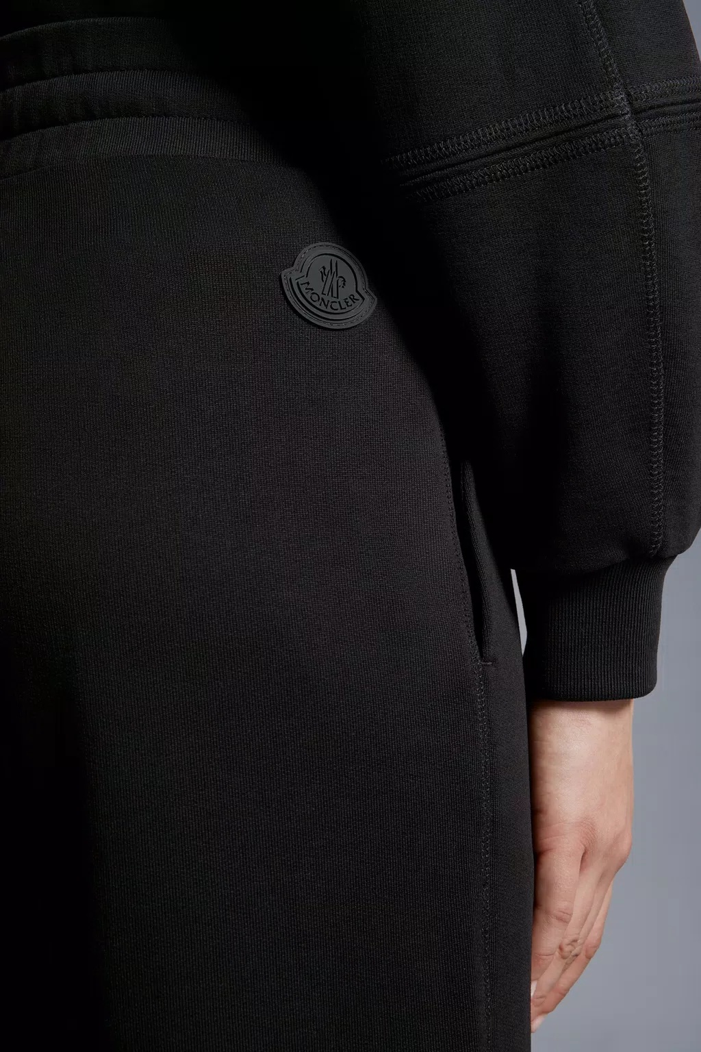 Shop Moncler Embossed Logo Trackpants In Black