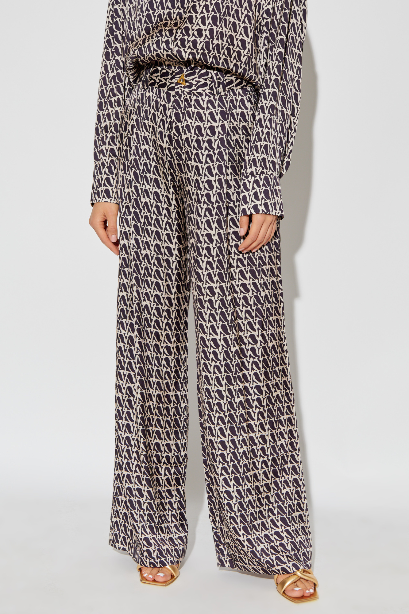 Shop Aeron Wellen Monogram-print Trousers In Black