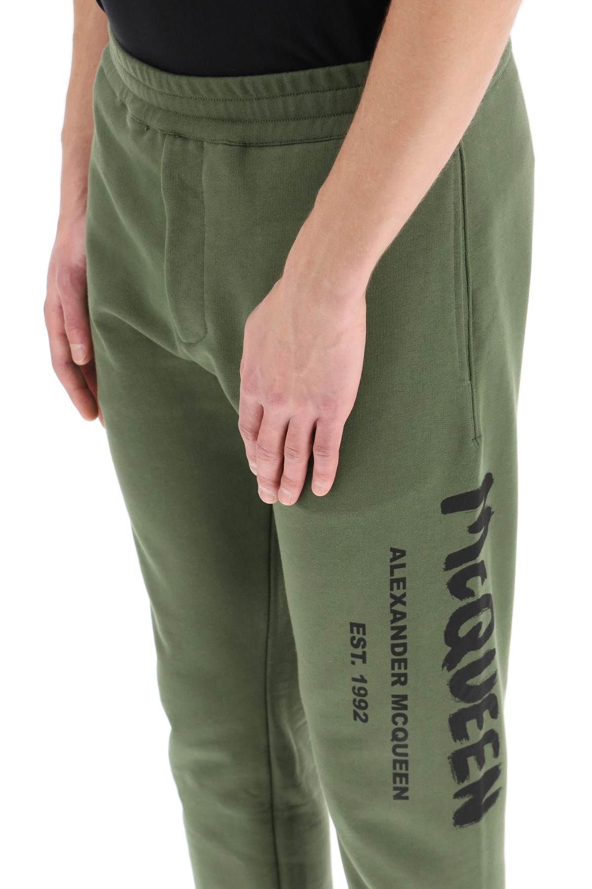 Alexander Mcqueen Logo Print Tapered Track Trousers In Green