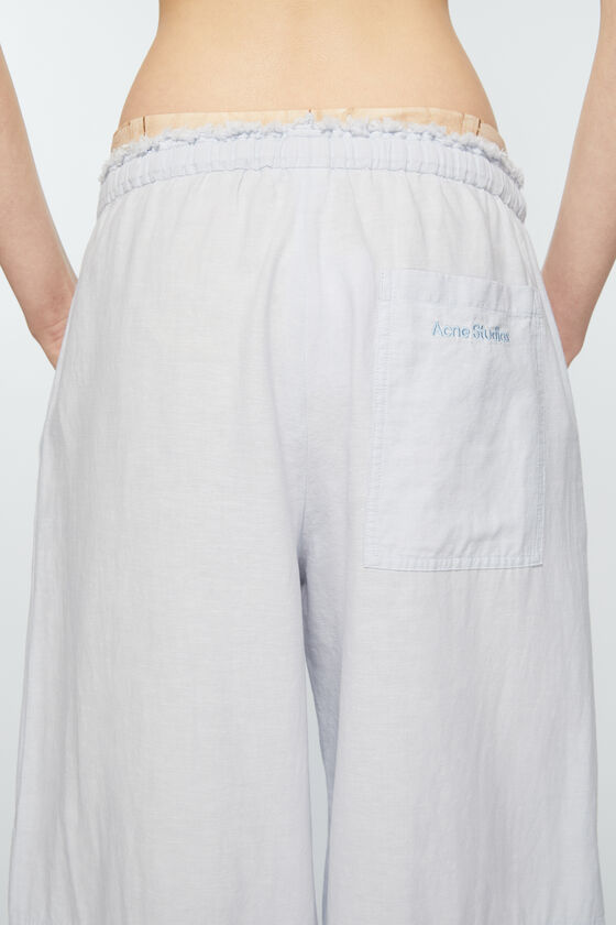 ACNE STUDIOS EMBROIDERED-LOGO WIDE-LEG TROUSERS 