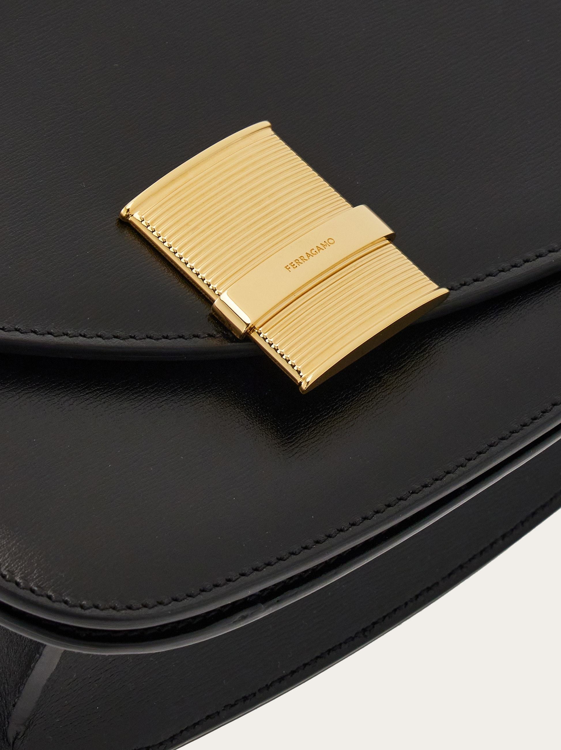 Shop Ferragamo Flip Shoulder Bag In Black