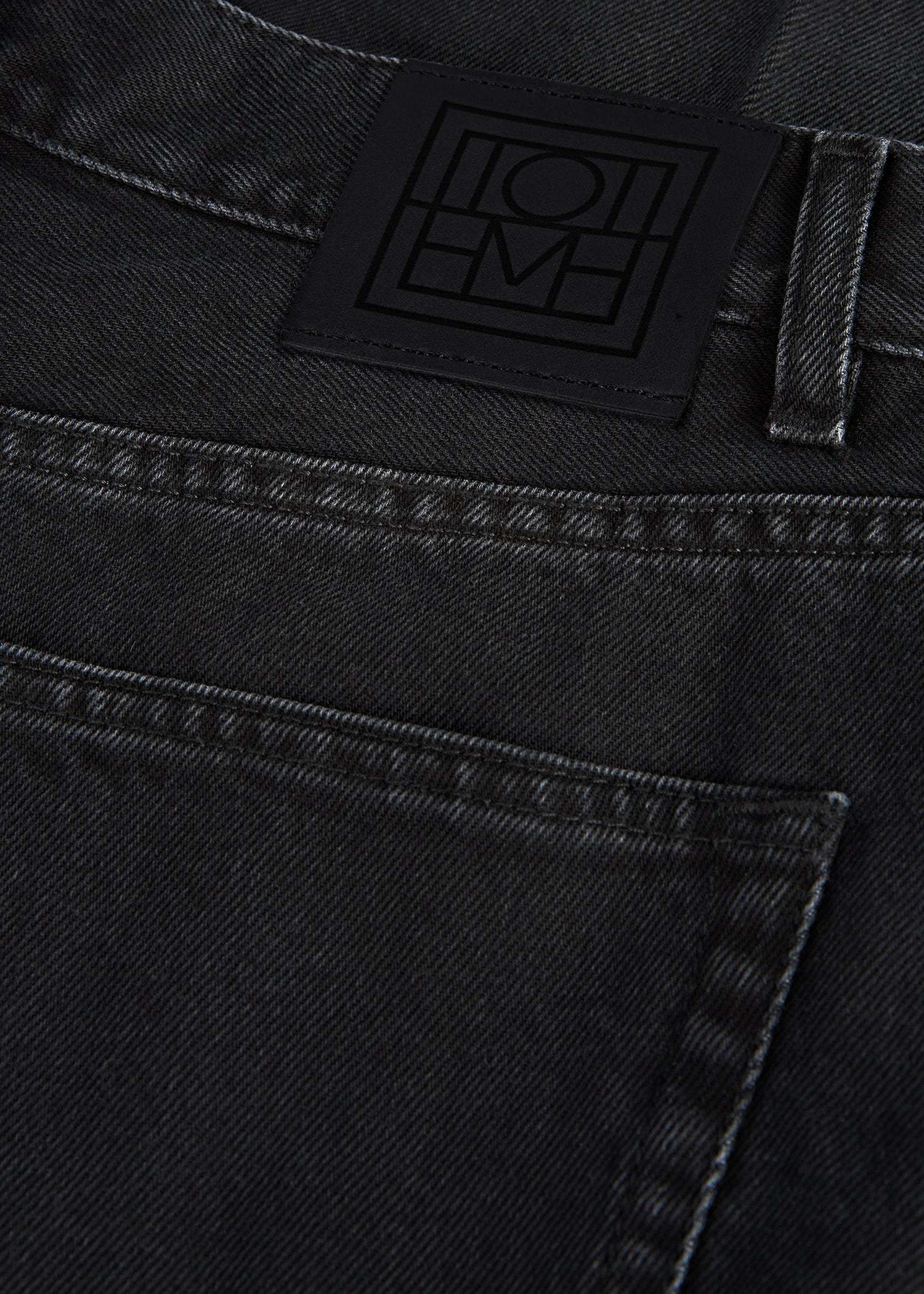 Totême Faded-effect Tapered-leg Jeans In Black