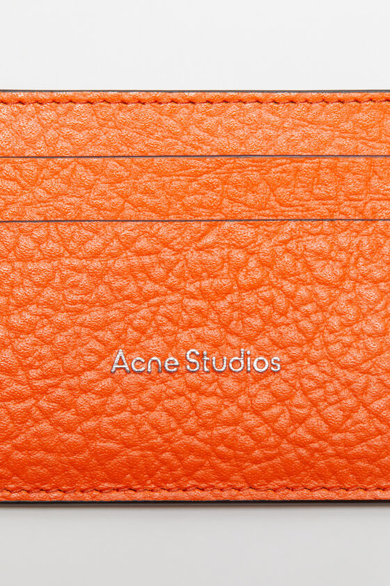 Acne Studios Embossed Logo Clip In Orange