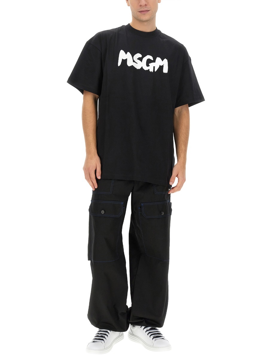 Msgm Contrasting-stitch Logo-patch Trousers In Black