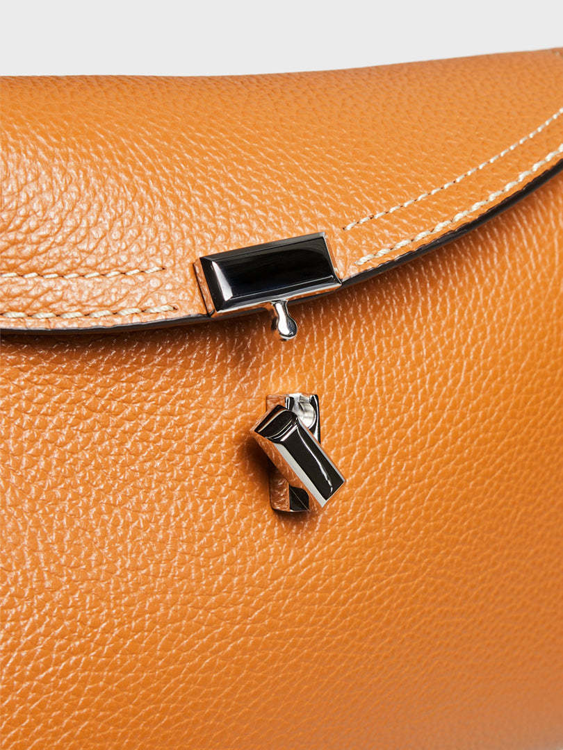 Totême T-lock Top Handle Bag In Pebble Grain Leather In Orange