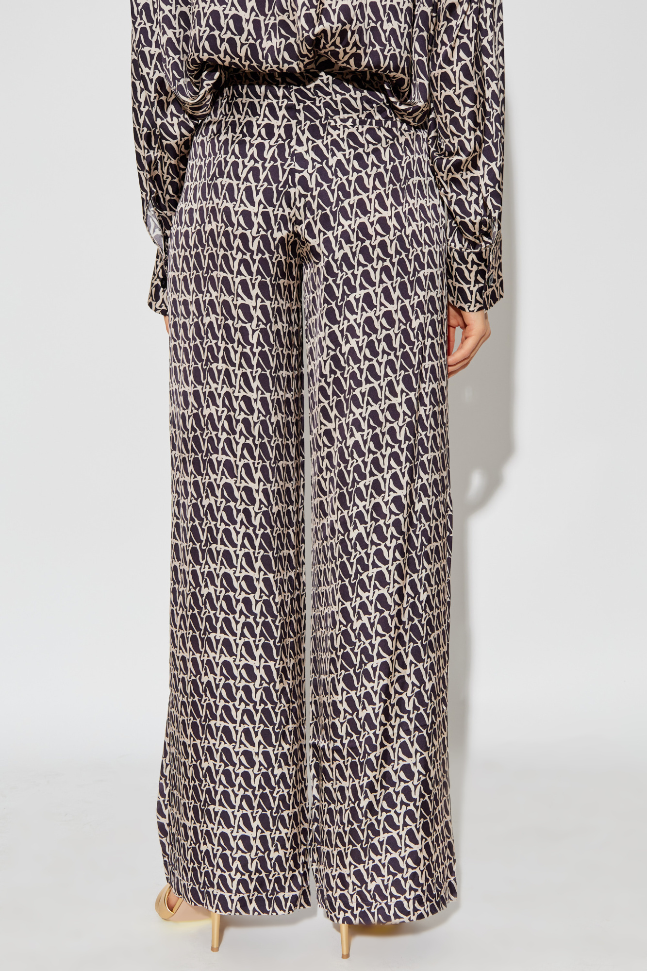 Shop Aeron Wellen Monogram-print Trousers In Black
