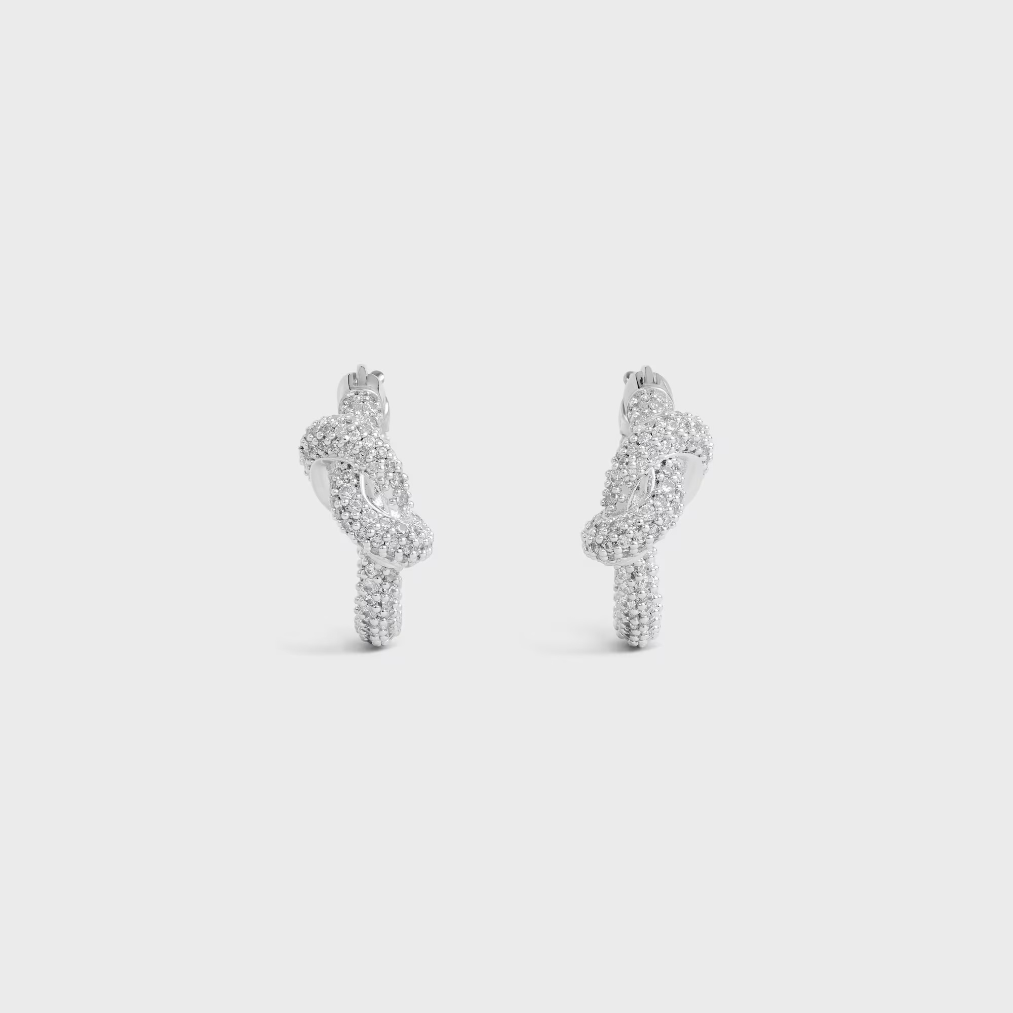 Celine Knot Sparkle Hoops In Strass And Brass With Rhodium Finish In Silver