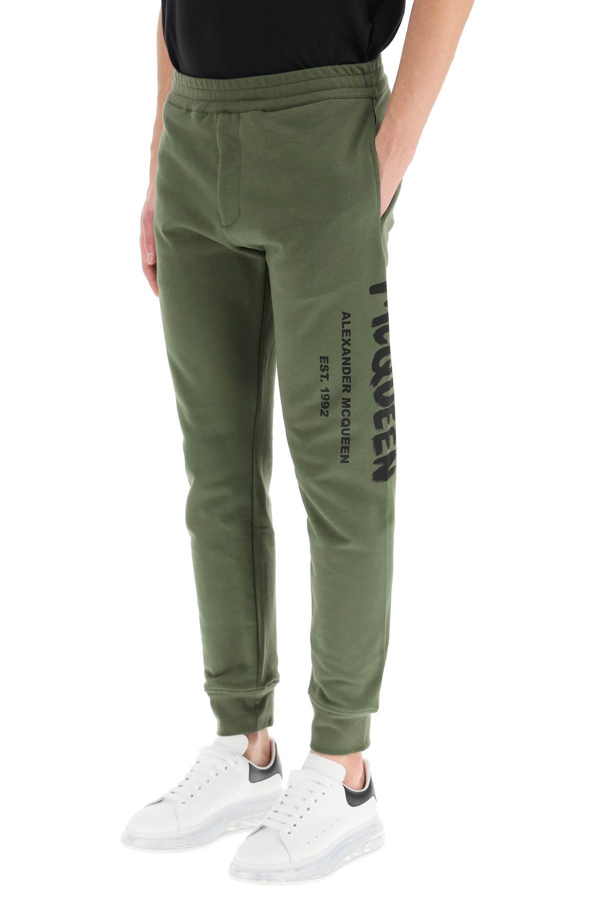 Alexander Mcqueen Logo Print Tapered Track Trousers In Green