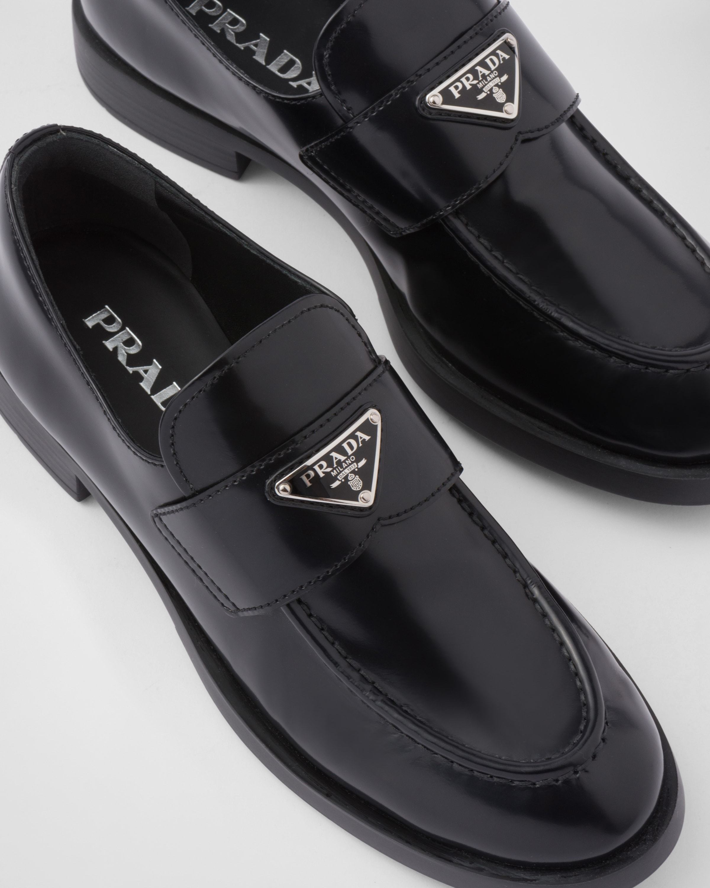Prada Logo Plaque Almond-toe Loafers In Black